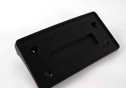 Soporte para matrícula OEM 51113414604 para BMW E83. Original BMW.