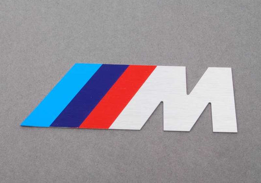 Emblema letra "M" frontal OEM 72601312802 para BMW E34 M5 (HD91, HD92, HC91, HC92, HJ91). Original BMW.