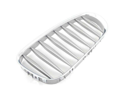 Rejilla decorativa izquierda OEM 51117117757 para BMW Z4 E85 (todos los modelos: 2.0i, 2.2i, 2.5i, con cambio manual y automático). Acabado en grafito. Original BMW.
