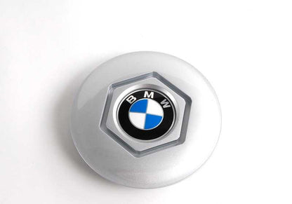 Central tire lid 36131180113 for BMW E34 and E32. Diameter 169mm. Compatible with several 518i and 518g models. Original BMW piece.