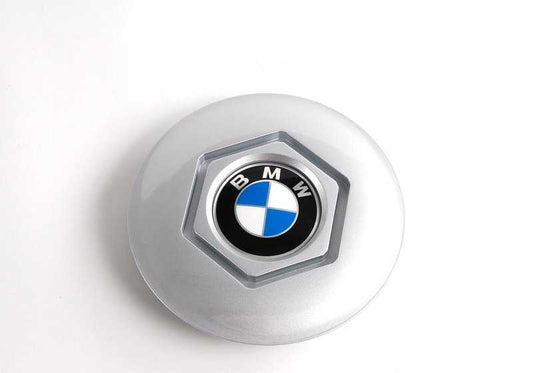 Central tire lid 36131180113 for BMW E34 and E32. Diameter 169mm. Compatible with several 518i and 518g models. Original BMW piece.