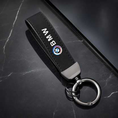 Llavero BMW 50 aniversario con cinta negra tipo cuero y aro metálico - vista principal premium